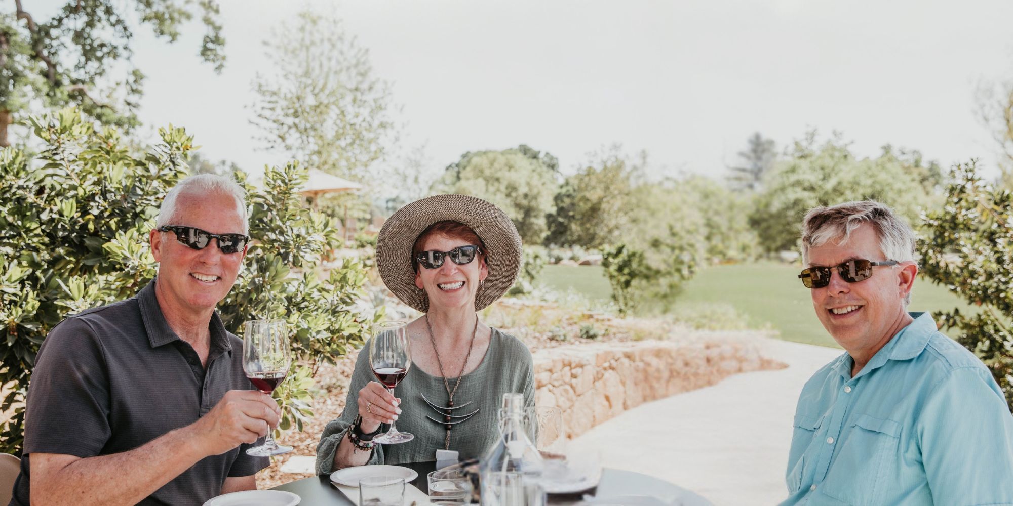 Three people enjoying Casino Mine Ranch wine on the patio.