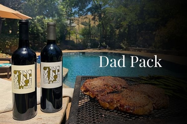 Casino Mine Ranch wine bottles of Zinfandel and Tempranillo poolside with a grill cooking meat and asparagus.