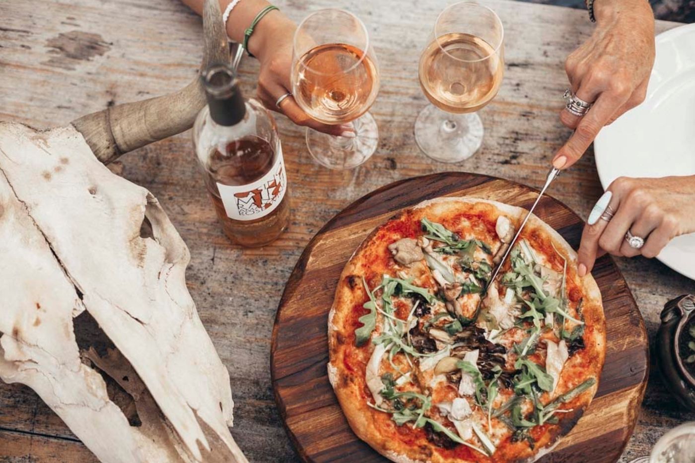 Casino Mine Ranch Winery rose wine and wood-fired pizza with a bull skull.